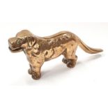 A solid brass anrique nut cracker in the form of a dog.