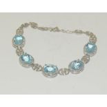 A silver and aquamarine bracelet.