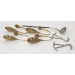 A whalebone ladle, brass curtain tie backs and pair of boot pullers.