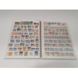 A multi-coloured stamp album 233 New Zealand.