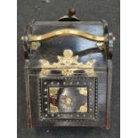 A vintage oak coal scuttle with scoop.