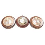 Three Prattware lids mounted on wooden plaques.