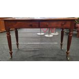 Victorian mahogany two drawer writing desk on turned supports with porcelain castors.