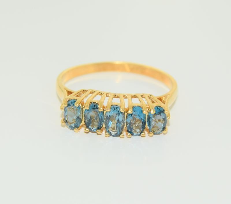 9ct gold on silver blue topaz ring. Size M.