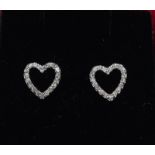 An 18ct white gold pair of heart shaped diamond set earrings.