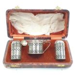 A silver hallmarked three piece condiment set in fitted box.