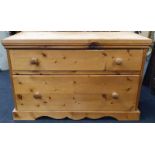 Low two drawer pine chest of drawers.