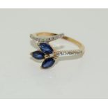 A 10ct gold ladies diamond and sapphire ring, Size M.