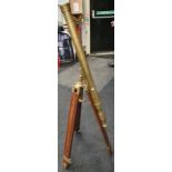 A brass telescope on tripod base.