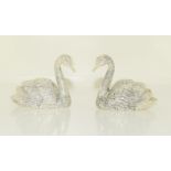 A pair of silver plated condiments in the form of swans.