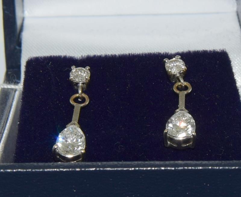 A pair of 18ct white gold and diamond drop earrings with Brilliant cut and pear shaped drop. - Image 2 of 2