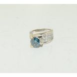A very impressive 14ct diamond ring by Sophia Fiori Venezia with central blue diamond, Chanel set