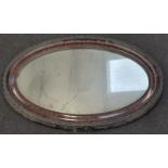 A vintage oval framed mirror.