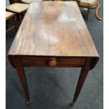 A mahogany single drawer Pembroke table on brass castors.