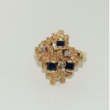 A 14ct ladies diamond and sapphire Aztek block ring.