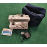 Riccar electric sewing machine in storage bag (WP114).