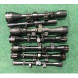 Seven rifle scopes (REF 145).