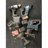 Four Bosch cordless drills, 4 x batteries and charging unit (REF 32).