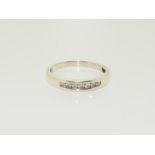 A 9ct white gold ladies 7 stone diamond ring, approx 0.33ct, Size V.