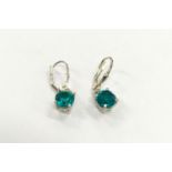 Pair of silver and turquoise earrings.