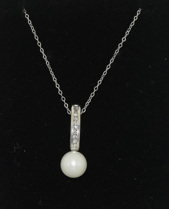 A diamond and pearl drop pendant necklace.