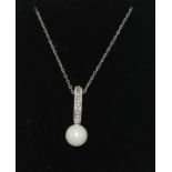 A diamond and pearl drop pendant necklace.