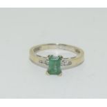 An 18ct white gold emerald and diamond ring, size N. 3.2 grams.