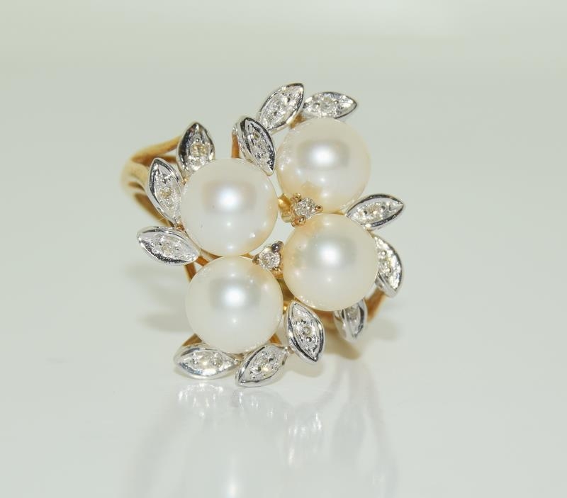 A 9ct gold ladies diamond and pearly cluster ring, Size N.