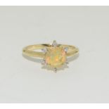 A Natural fiery opal and diamond 9ct gold ring, size N 1/2.