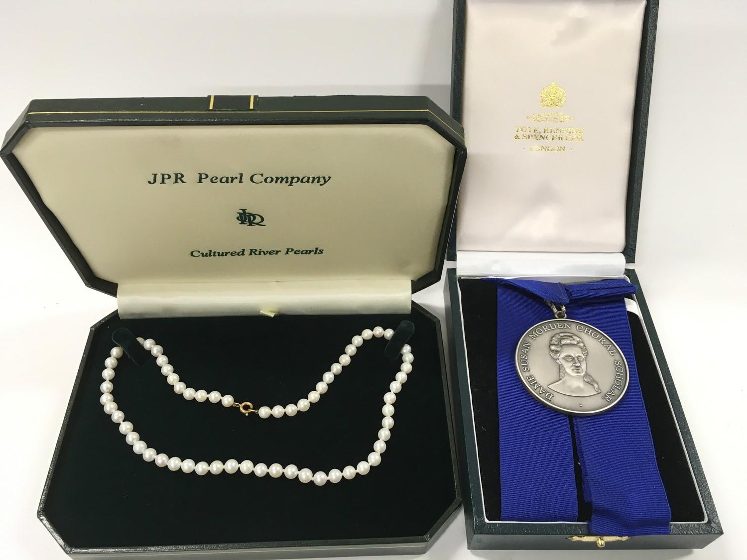 A Silver hallmark Choral Society medal together with a set of Pearls with a 9ct Gold clasp.