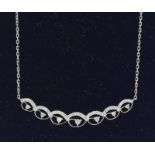An 18ct white gold diamond necklace of 50points.