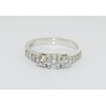 Moissanite 3 stone approx 0.5 points and sidestone set in 9ct White Gold ring in original box.