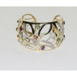 A 14ct yellow gold bangle set with diamonds, citrines, peridot etc.