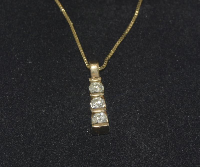 Diamond 3 stone drop pendant 0.25 ct on 9ct Gold chain.