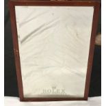 A wood framed and bevel edged mirror, etched Rolex. 80 cm by 53 cm