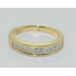 An 18ct yellow gold diamond set half eternity ring. Size N