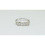 An 18ct white gold Princess cut half eternity band, Size Q, 6.7grams