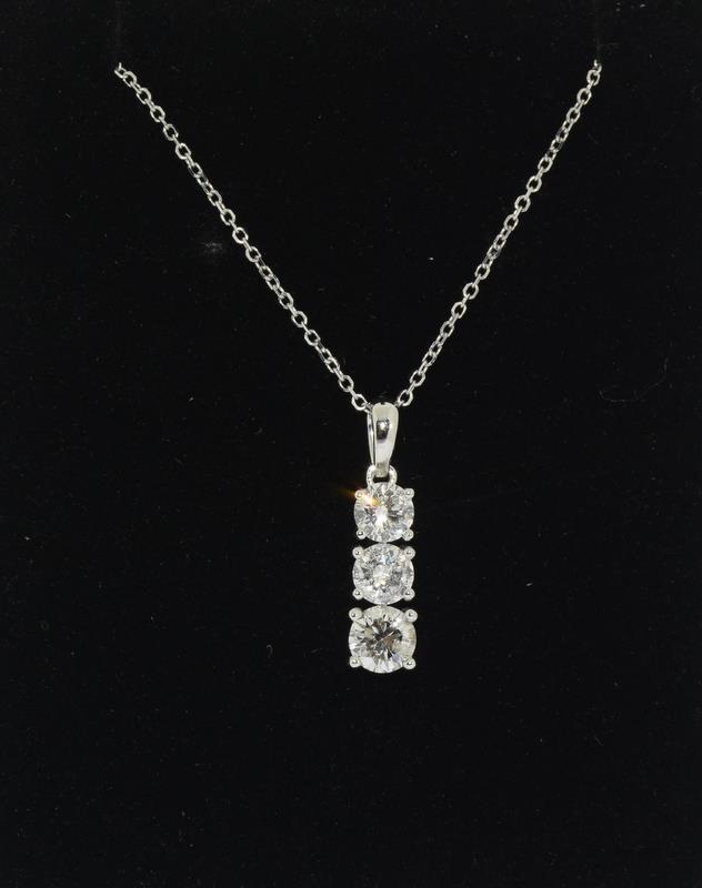 An 18ct white gold three stone diamond pendant necklace of 90 points approx.