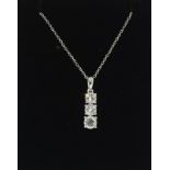 An 18ct white gold three stone diamond pendant necklace of 90 points approx.