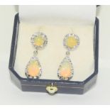 A pair of 18ct white gold fiery natural opal and diamond drop earrings, (backs not fitting properly)