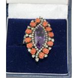 A large diamond, coral and amethyst ring in silver, Size M.