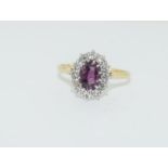 A 14ct white gold ruby and diamond cluster ring of 1.8cts Approx. Size T