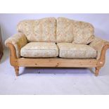 A Ducal pine framed two seat sofa, 60" wide