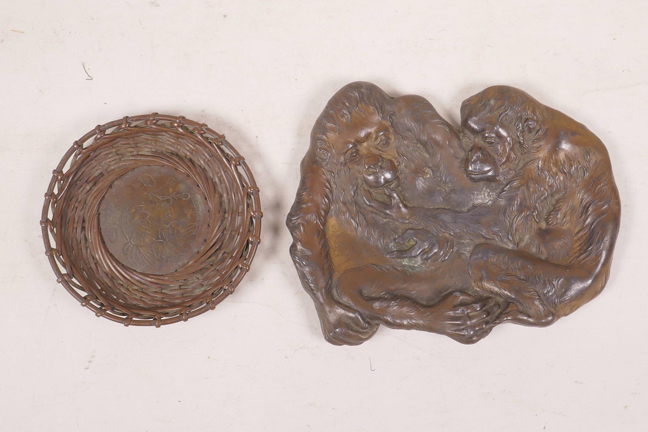 A Japanese Meji bronze shallow dish in the form of two monkeys, together with a Meiji woven bronze