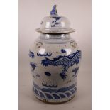 A Chinese blue and white storage jar and cover with four fo dog mask lugs, decorated with dragons,