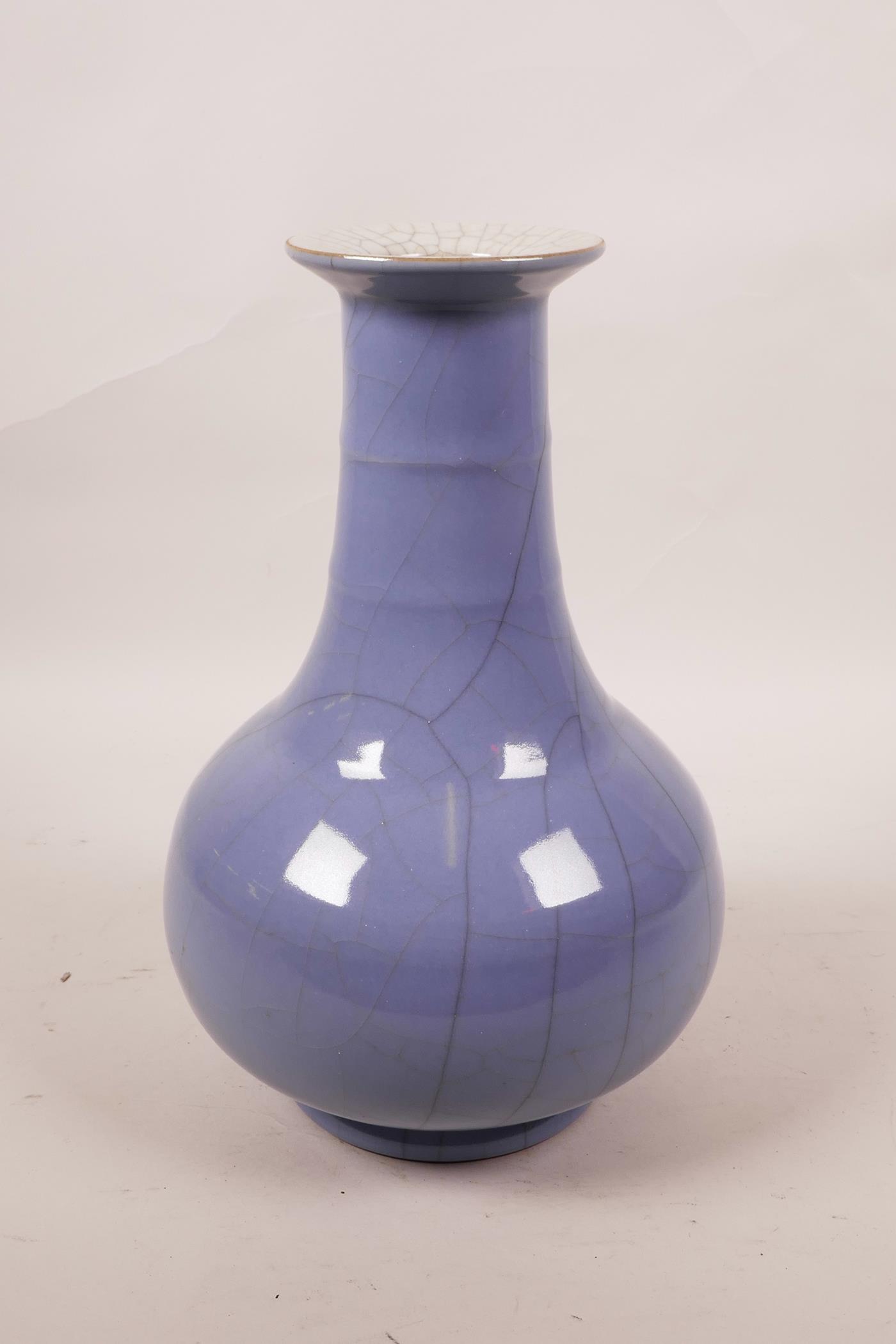 A Chinese blue glazed crackleware vase with a ribbed neck, 9" high