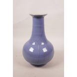 A Chinese blue glazed crackleware vase with a ribbed neck, 9" high