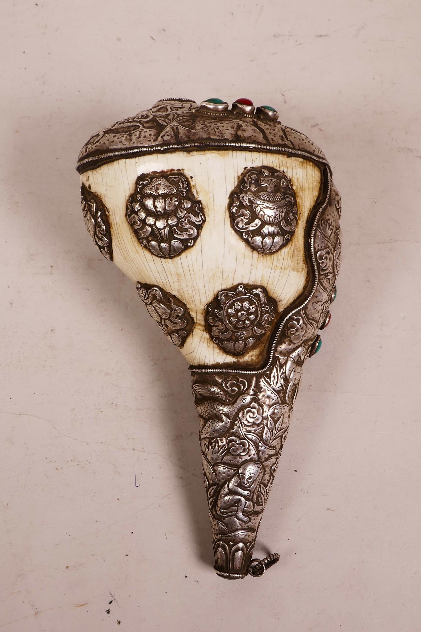 A large Tibetan white metal mounted conch shell, with repoussé decoration of the eight Buddhist - Image 2 of 4