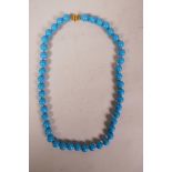 A turquoise bead necklace with a gold clasp, marked 750, 18" long