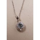 An 18ct white gold, blue topaz and diamond set pendant necklace, approximately 90 points